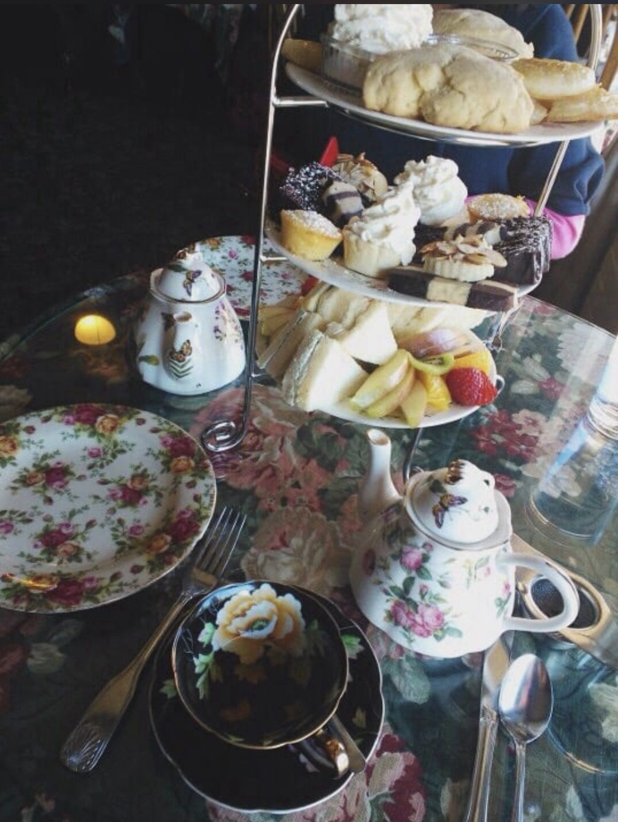 Afternoon tea at the tea room: a three-tier stand of scones, sweets and tea sandwiches with floral china teapots