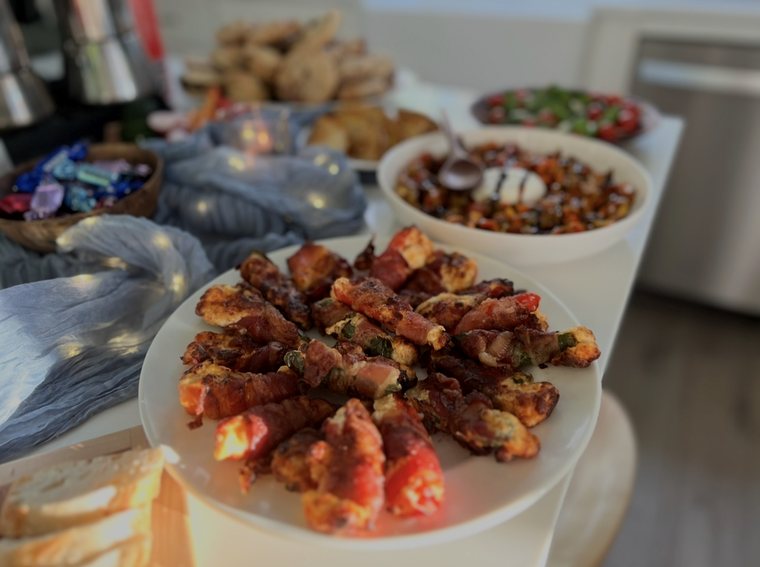 A platter of bacon-wrapped stuffed peppers
