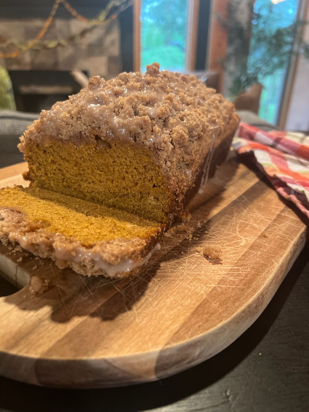 A loaf of pumpkin bread with a cinnamon crumb top