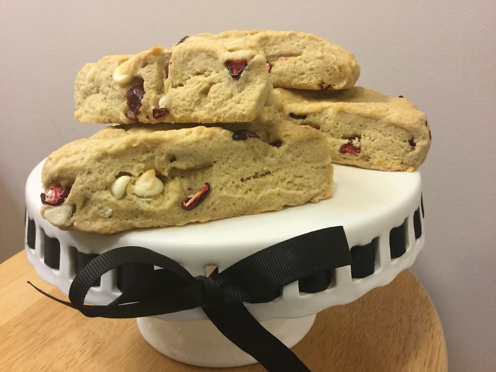 Cranberry, rosemary and white chocolate scones on a cake stand