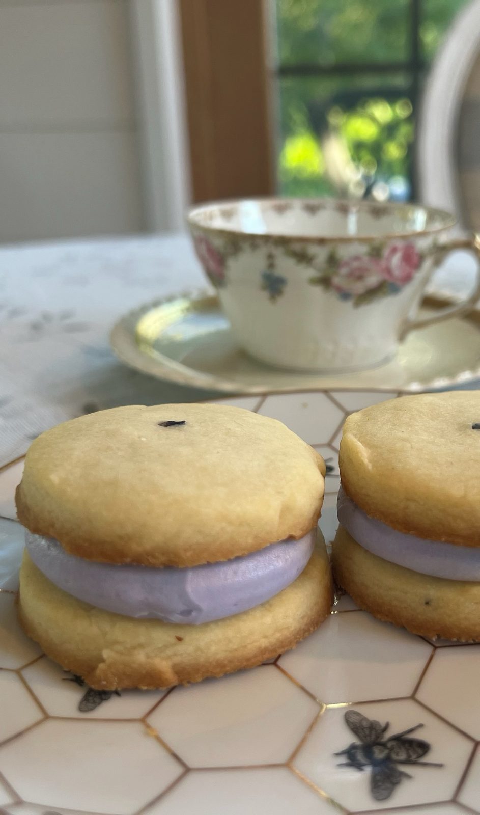 Lavender crème shortbread beside a vintage teacup